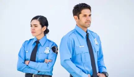 Officers posing in front of white wall